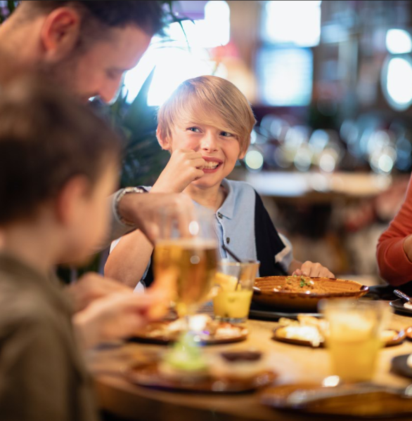 Boy with Family Eating in a Restaurant